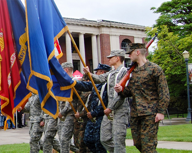 military members hold flags in MU Quad