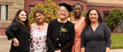 Janet Nishihara, center, and Educational Opportunities Program colleagues pose outside of Waldo Hall. 