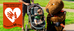 toddler interacts with Benny the Beaver