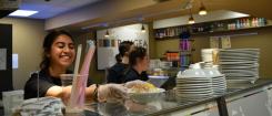 Students prepare food during the Pangea Cafe Takeover Event