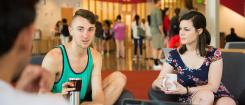 students converse in Student Experience Center