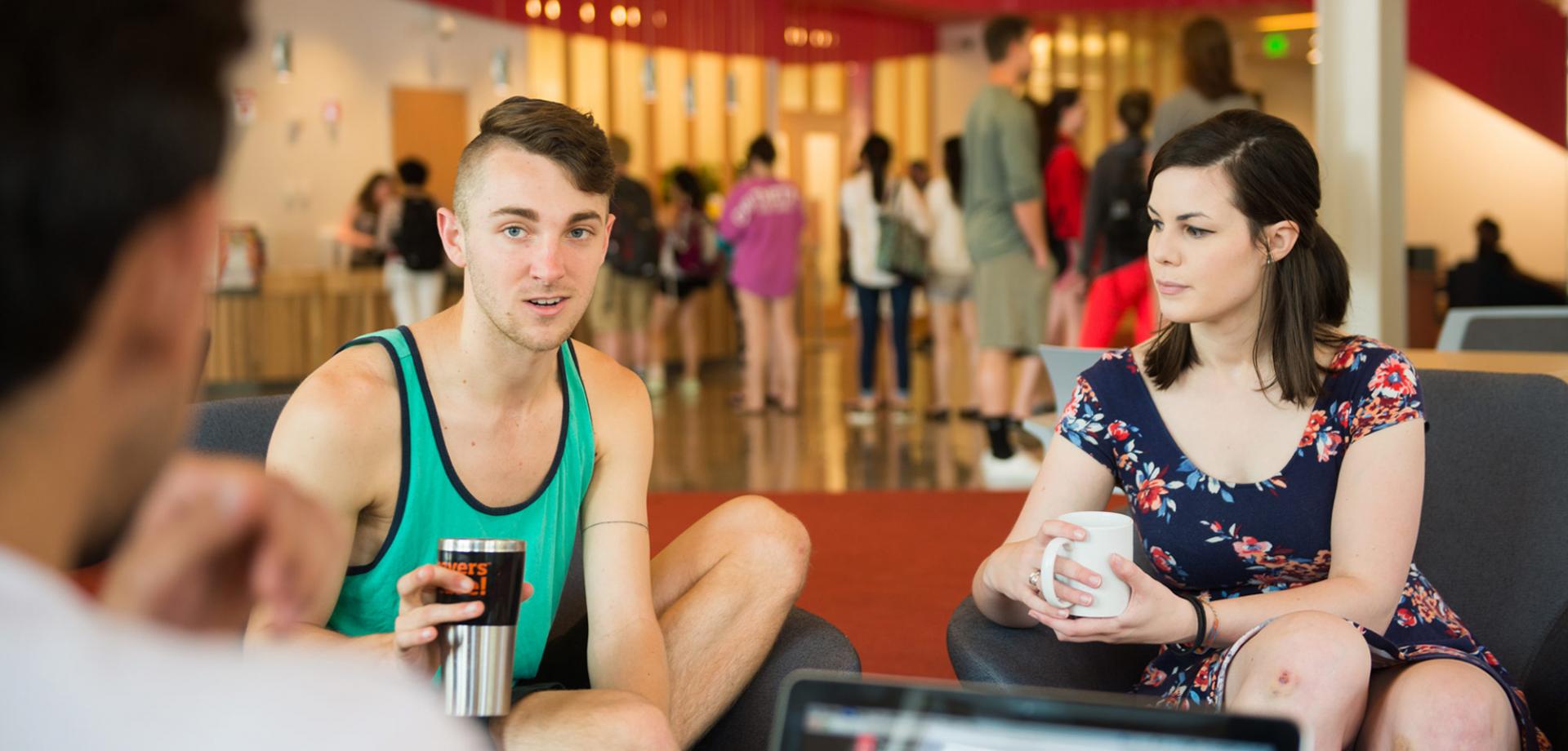 students converse in Student Experience Center